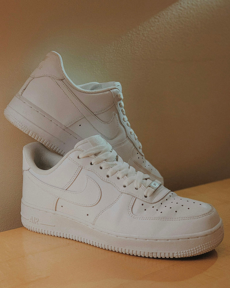 Sneakers — Nike Air Force 1 Triple White stacked editorial · LGND