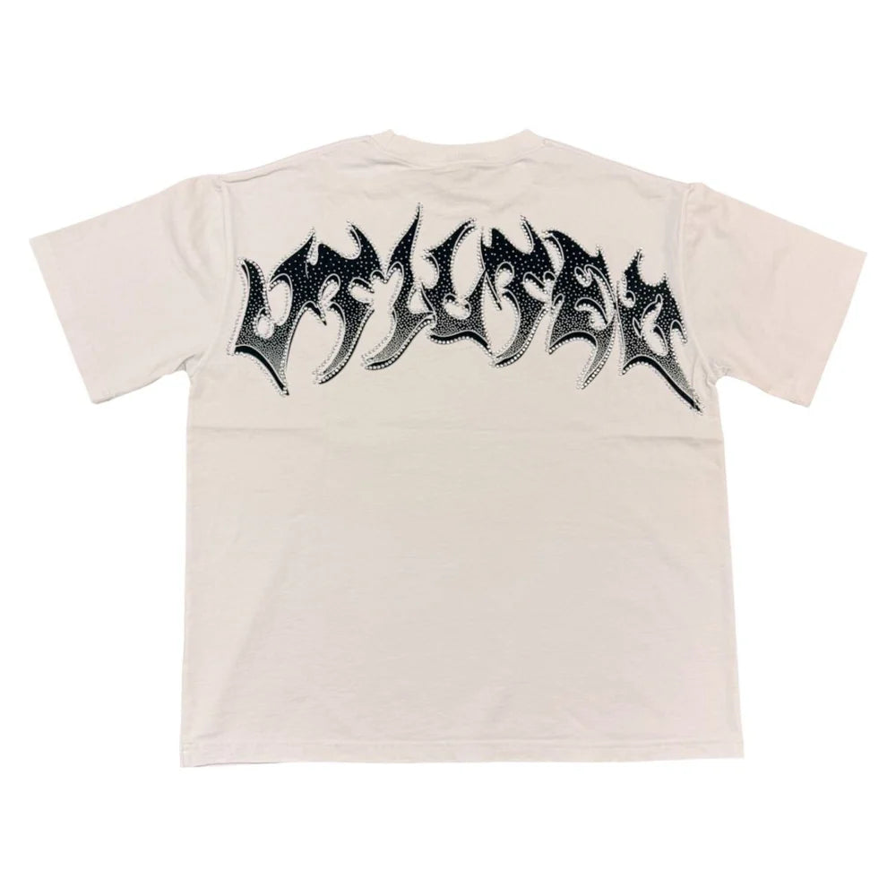 Vtilted "BLINDED" oversized graphic tee in White — a blindfolded praying child rendered in chiaroscuro oil-painting style, surrounded by storm clouds, roses, and butterflies — a meditation on