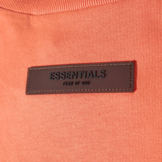 Fear of God Essentials Tee - Coral — Jerry Lorenzo Essentials heavyweight basic, short-sleeve cotton tee, front view