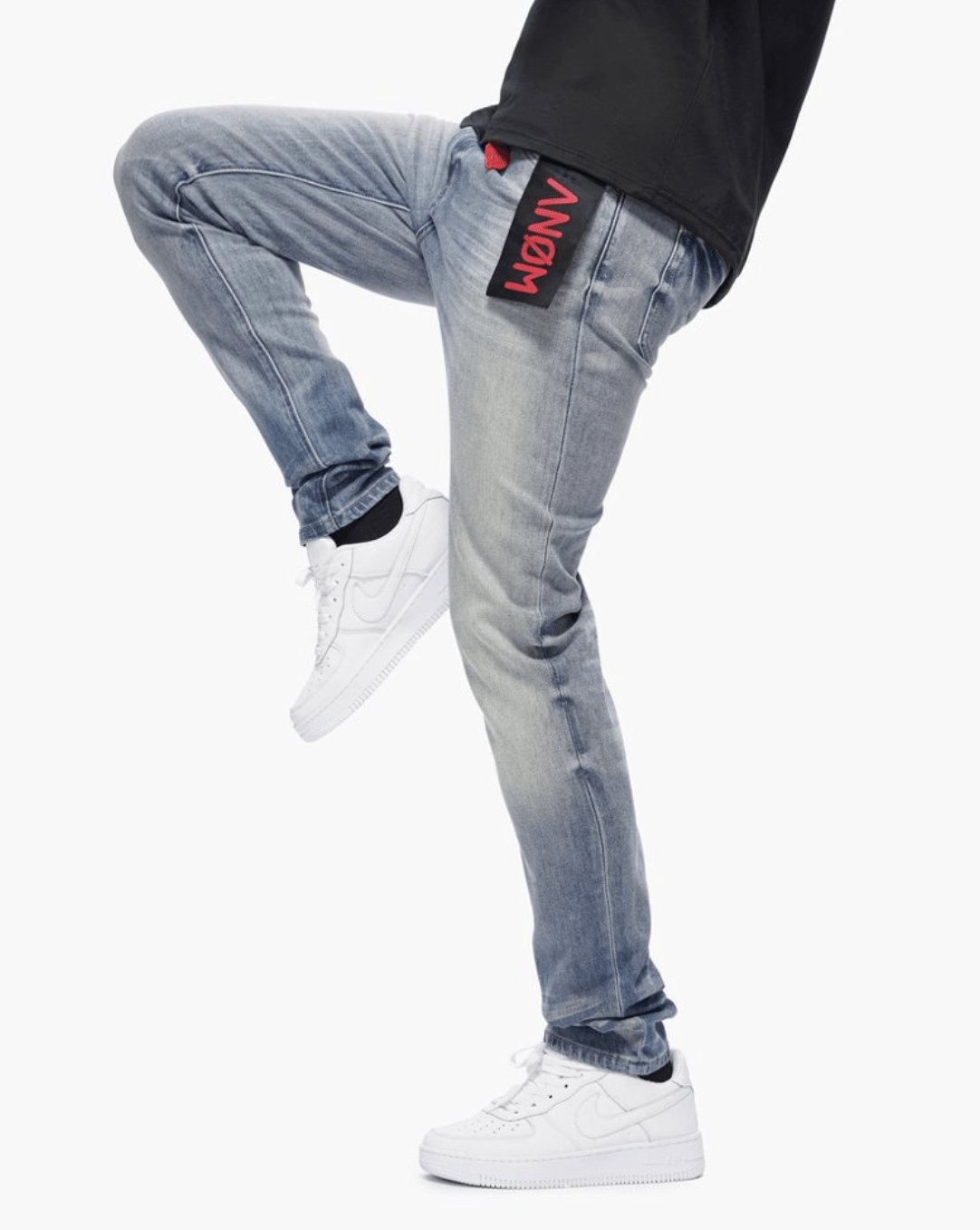 Anom 360 Skinny in Blue Wash - medium-blue stretch denim skinny with vertical thigh whiskering, knee fading and red Anom flag patch