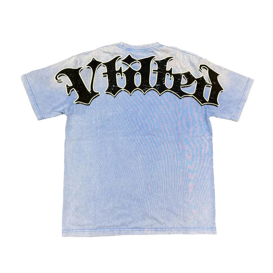 Vtilted "META" oversized graphic tee in Blue Jean — a child wearing a VR headset surrounded by cosmic static, asking "WILL I LET THIS EARTH BE RULED?" and "The Future Is Here&qu