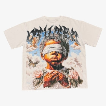 Vtilted "BLINDED" oversized graphic tee in White — a blindfolded praying child rendered in chiaroscuro oil-painting style, surrounded by storm clouds, roses, and butterflies — a meditation on