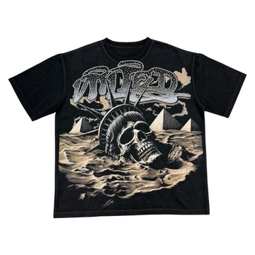 Vtilted "DESERTED" oversized graphic tee in Jet Black — a Statue of Liberty skull half-buried in desert dunes with distant pyramids — a post-apocalyptic riff on broken empires