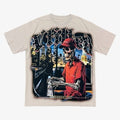 Vtilted "MANIFESTED" oversized graphic tee in Gray — a sharp-dressed skeleton in a red coat against a glowing city skyline, marked "MMXV" — a manifestation icon from the Vtilted mytho